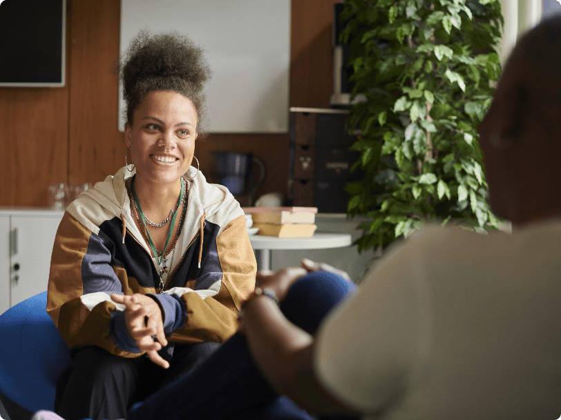 An occupational therapist talking with a client at home